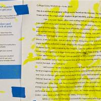 A close-up of the paper quilt, featuring a hilighter-ink-spattered handout of an example of a college entrance essay with hard-to-believe stories about the author's life